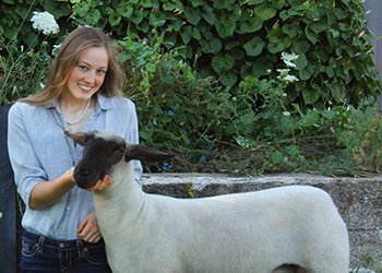 A Mansitee 4-H student with a lamb